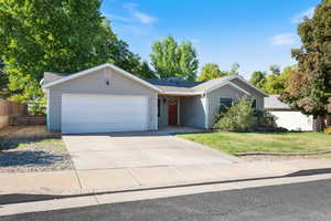 Single story home with driveway, a garage, and roof with shingles