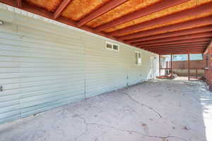 View of patio with a carport