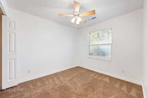Unfurnished room with carpet and ceiling fan