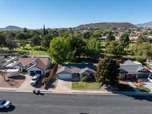 Aerial view of property and surrounding area featuring mountains