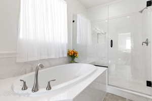 Full bath with a garden tub, a marble finish shower, and tile patterned floors