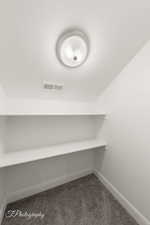 Detailed view of carpet and a smoke detector