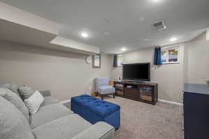 Carpeted living area featuring baseboards - or bedroom