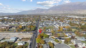 Aerial view of property's location featuring nearby suburban area and a mountain backdrop