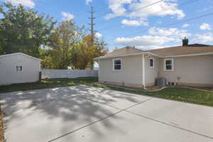 Rear view of property featuring roof with shingles