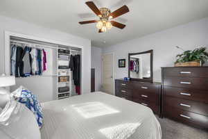 Bedroom with light carpet, a closet, and ceiling fan