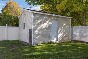 View of shed featuring a fenced backyard