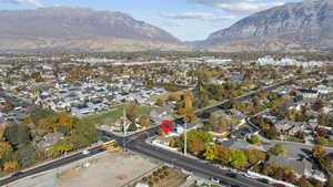 Aerial view of property's location featuring a mountain backdrop and nearby suburban area