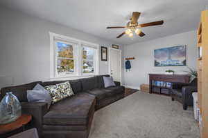 Living room featuring ceiling fan and wood finished floors