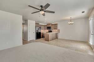 Kitchen with open floor plan, black appliances, recessed lighting, decorative backsplash, and a ceiling fan
