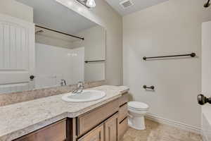 Full bath featuring vanity and light tile patterned floors