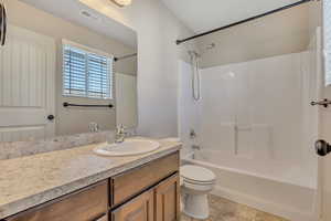 Bathroom featuring tub / shower combination and vanity