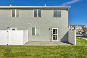 Rear view of house featuring stucco siding