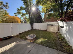 Fenced backyard featuring a patio area and a gate