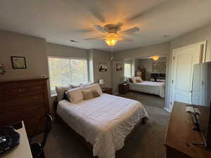 Master Bedroom featuring dark carpet, a closet, and ceiling fan