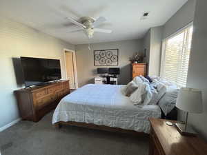Bedroom with carpet floors and a ceiling fan