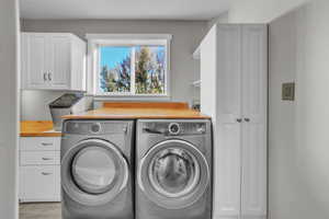 Washroom with washer and dryer and cabinet space
