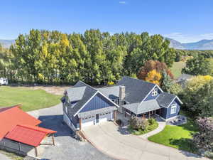 Aerial view of property and surrounding area with mountains