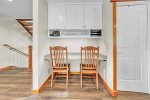 Dining area featuring light wood-style flooring and built in desk