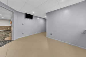 Finished below grade area with a paneled ceiling and recessed lighting