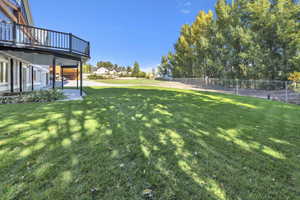 View of yard featuring a patio area and a deck