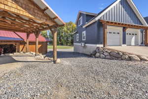 View of side of property with driveway and board and batten siding