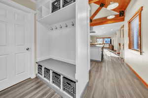 Mudroom with light wood-style floors, wooden ceiling, and recessed lighting