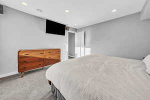 Bedroom with recessed lighting and light colored carpet
