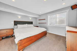 Bedroom featuring light colored carpet and recessed lighting