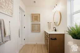 Bathroom featuring vanity and light wood finished floors