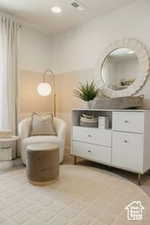 Sitting room with light tile patterned floors and recessed lighting