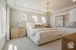 Bedroom with a chandelier, a tray ceiling, and recessed lighting