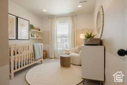 Bedroom featuring a crib and recessed lighting