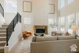 Living area with stairway and a towering ceiling