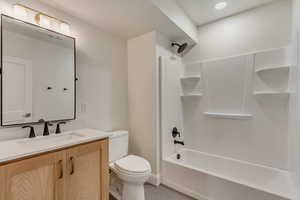 Bathroom featuring vanity, shower / tub combination, and recessed lighting