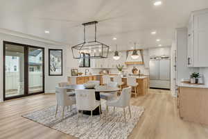 Dining room featuring light wood finished floors, recessed lighting, and a chandelier