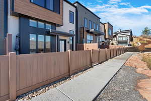 View of patio featuring a fenced front yard and a residential view