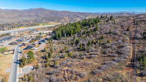 Aerial overview of property's location featuring a mountainous background and nearby bike trails