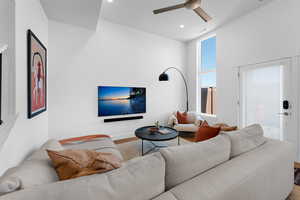 Living room featuring wood finished floors, a ceiling fan, and recessed lighting