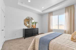 Bedroom with a tray ceiling, carpet flooring, and recessed lighting