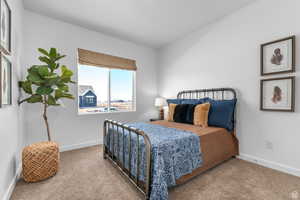 Bedroom with carpet flooring and baseboards