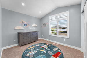 Bedroom featuring vaulted ceiling, light carpet, and recessed lighting