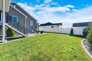 View of yard featuring a patio area and stairway