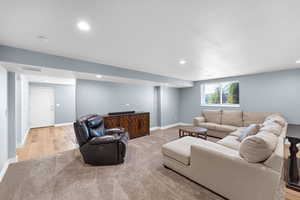 Living room with light carpet and recessed lighting