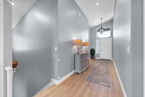 Entrance foyer featuring wood finished floors, high vaulted ceiling, and recessed lighting