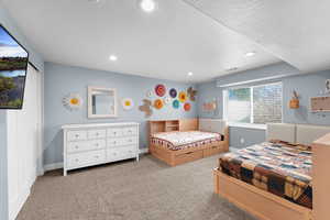 Bedroom with light colored carpet, recessed lighting, and a textured ceiling