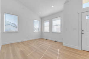 Living room off of entry with recessed lighting, high vaulted ceiling and mountain views