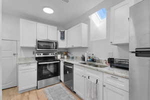 ADU kitchen with storage space behind small door