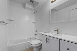 Bathroom featuring shower / tub combination, vanity, and wood finished floors