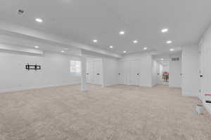 Basement family room looking east with double closet to the left of column. Picture shows plumbing for kitchen on the right (stair) wall.  Left of column could be turned into 2 more bedrooms. There is an existing bedroom to the right of the column